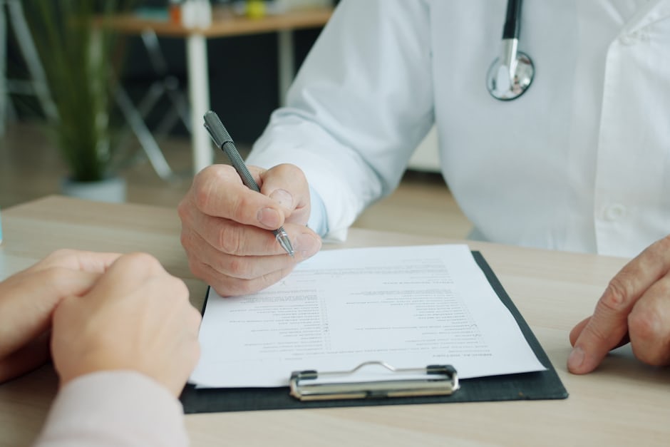 A patient and doctor discussing options across a consultation desk